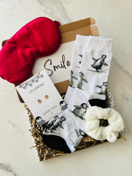 I Flippin’ Love You gift box featuring a fluffy scrunchie, sleep mask, penguin earrings, and penguin-themed socks, all beautifully arranged in a letterbox-friendly package.